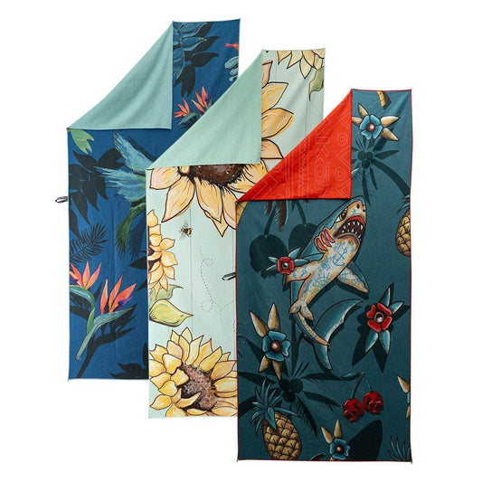 Colorful Akona Micro Fiber Towel with floral and shark designs, ideal for travel and outdoor use.